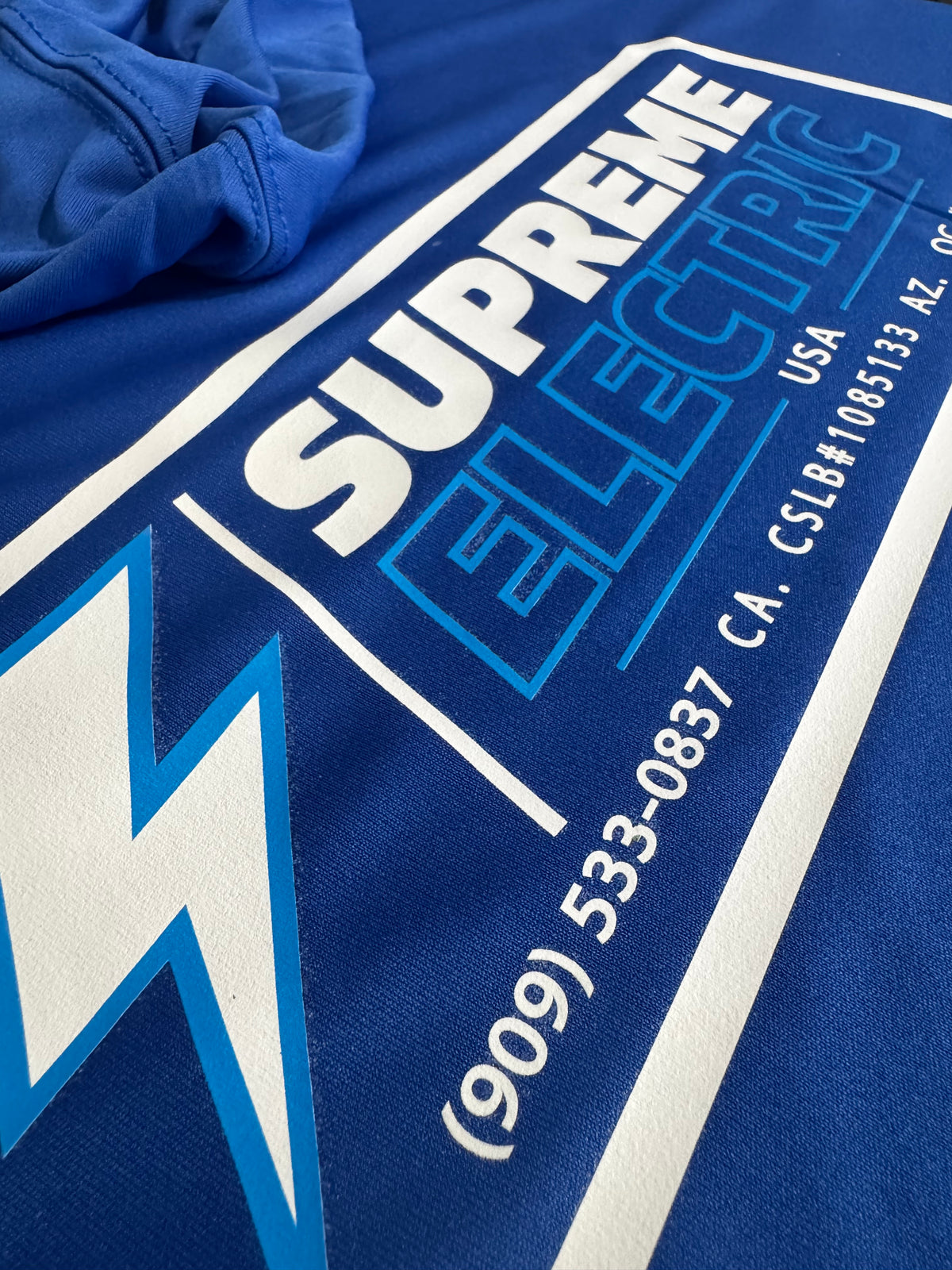 Close-up of blue-and-white DTF lettering with bright opaque white coverage on a dark blue garment.
