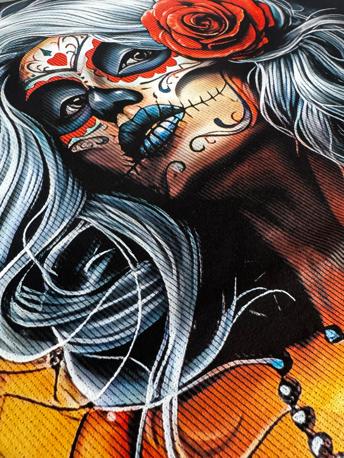 Close-up of a vibrant full-color DTF transfer featuring a Day of the Dead woman with silver hair and a red rose.